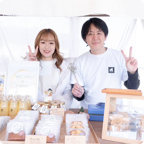 夫婦でイベント出店ブースに立つ様子